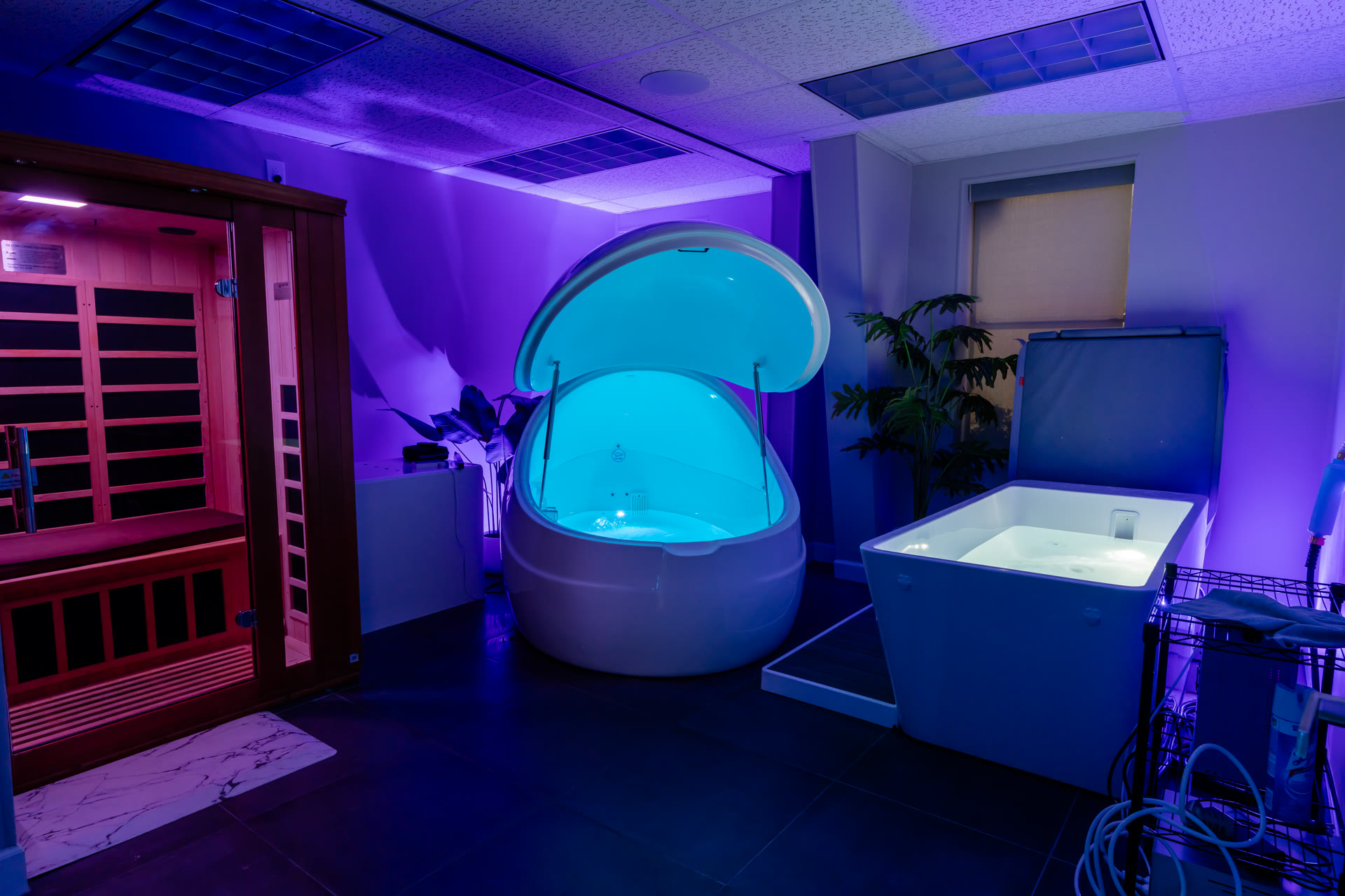 The recovery suite — infrared sauna, open float pod, and cold plunge in low ambient light