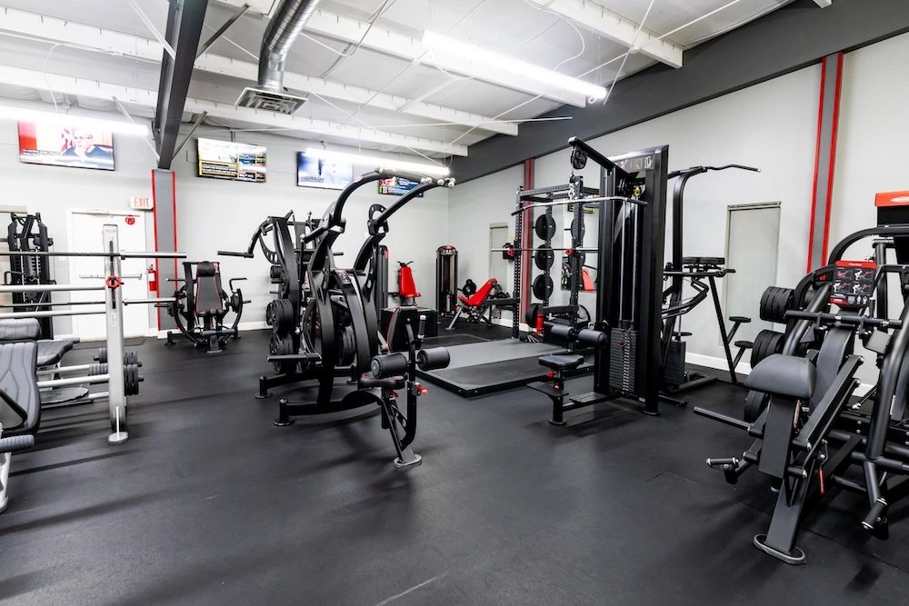 WEF strength rig &mdash; plate-loaded machines, cable tower, the working room
