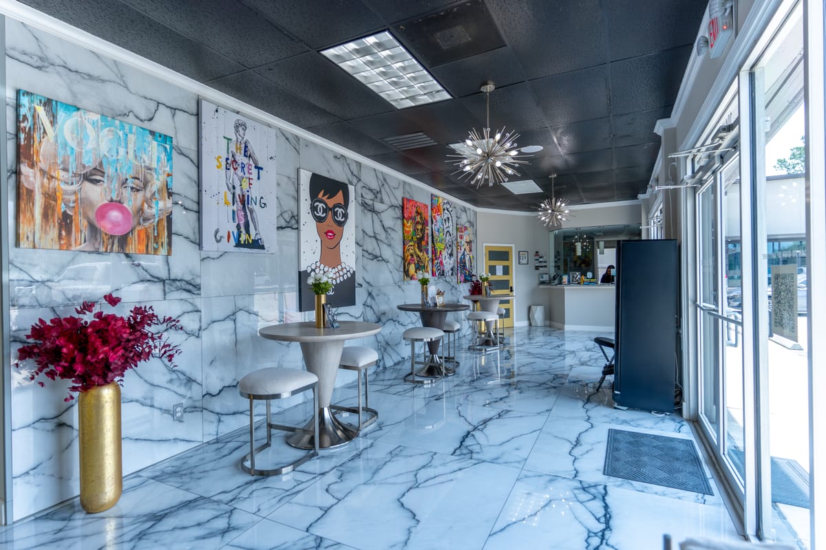 The lobby — marble walls, sputnik chandeliers, and gallery seating